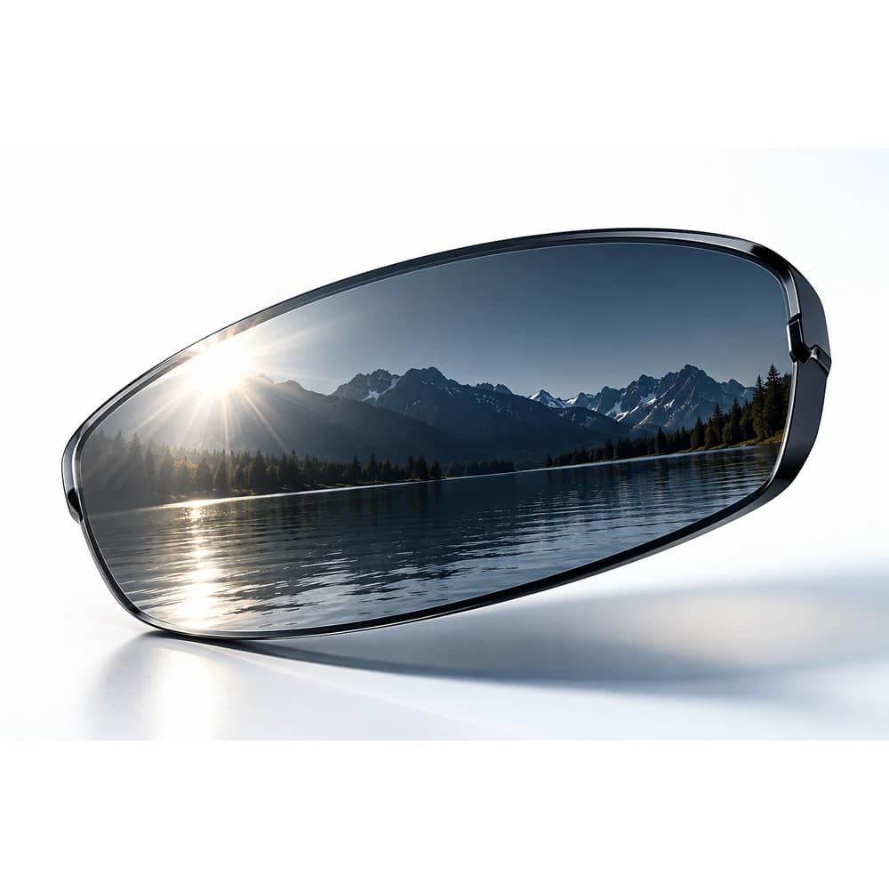 Polarised sports lens reflecting a bright mountain and water landscape.